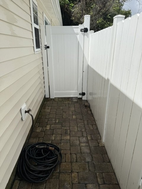 Fence after pressure wash — bright white, gate hardware clean