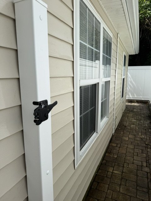 House after — wide view, siding clean under new-shingle roofline
